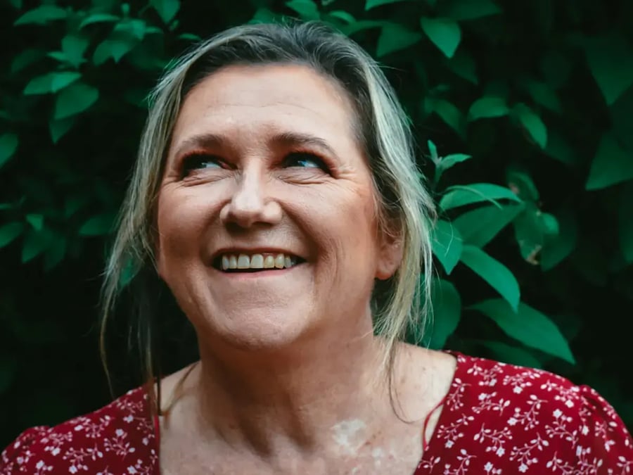 Stock photo: smiling woman in her fifties outdoors, natural look